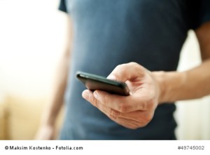 Close up of a man using mobile smart phone